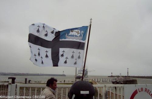 Drapeau de Saint-Nazaire. Un remorqueur accompagne le Campbeltown vers l\'Estuaire.